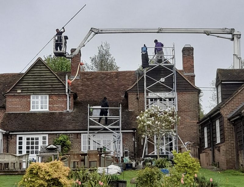 The Moss Cleaners using cherry picker and scaffolding to clean roof safely and professionally in Littlehampton, West Sussex